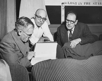 Author Alan Paton, composer Kurt Weill and playwright Maxwell Anderson, sitting together reading a script, circa 1950