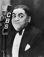 Fats Waller smiles in front of a CBS radio microphone circa 1935
