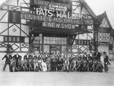 Pianist Fats Waller (front Center) poses with Les Hite (front in white) and his orchestra along with club owner Frank Sebastian and The Creole Dancing Revue at Frank Sebastian's New Cotton Club circa 1935 in Culver City, California.